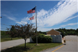 American flag at entrance to transfer station with outbuilding