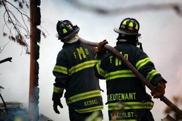 Two Firemen with a Hose